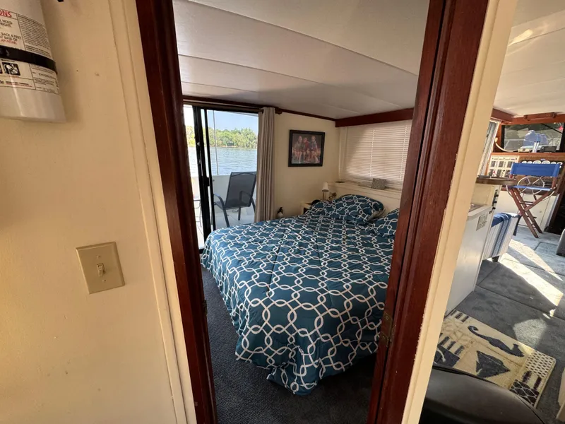 Slide: The Image of Cozy bedroom in 1985 Bluewater Yachts 51 Coastal Cockpit MY with lake view. - 18