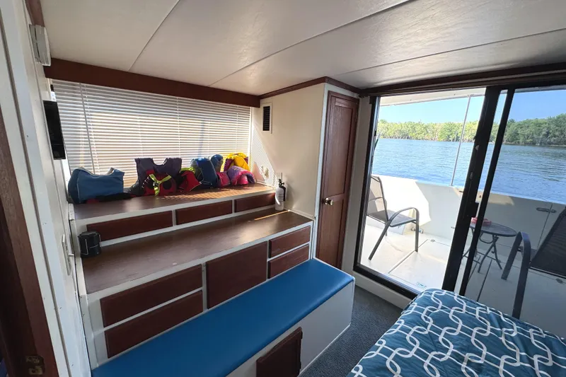 Slide: The Image of Interior of 1985 Bluewater Yachts 51 Coastal Cockpit MY with lake view and colorful life jackets. - 20