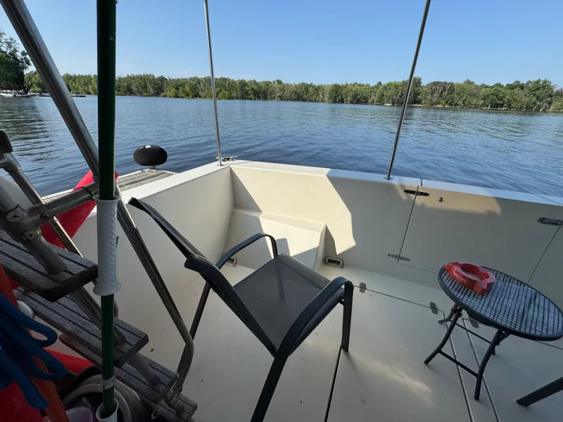 Slide: The Image of 1985 Bluewater Yachts 51 Coastal Cockpit MY, serene lake view from boat deck. - 22