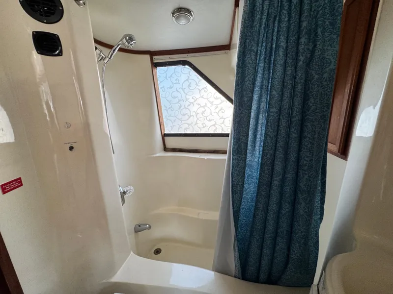 Slide: The Image of Shower area in 1985 Bluewater Yachts 51 Coastal Cockpit MY with blue curtain and window. - 29