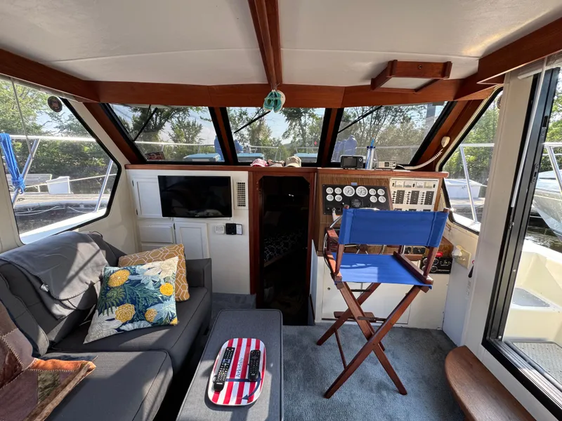 Slide: The Image of Interior of 1985 Bluewater Yachts 51 Coastal Cockpit MY with seating, helm, and decor. - 30