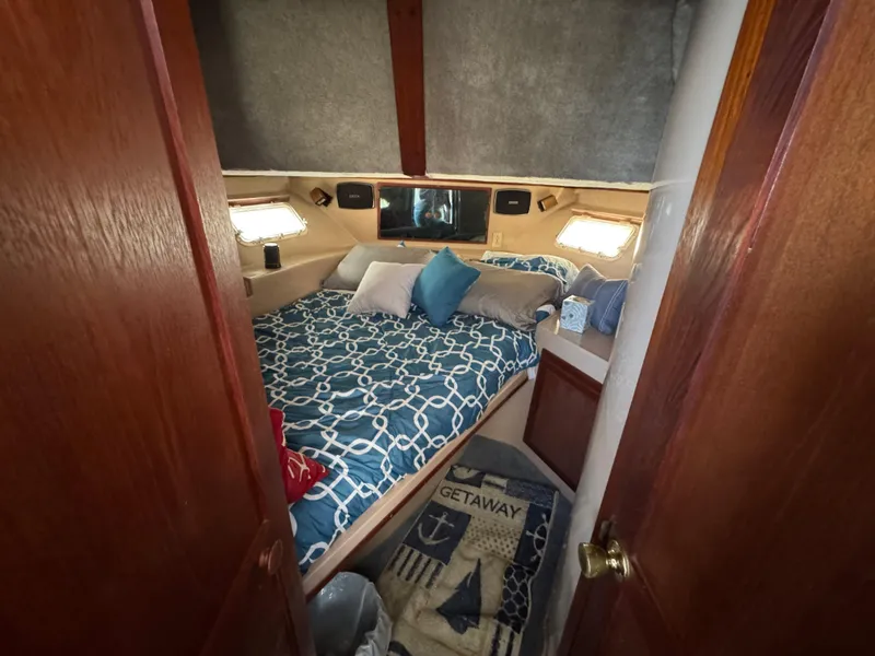 Slide: The Image of Cozy bedroom in 1985 Bluewater Yachts 51 Coastal Cockpit MY with nautical decor. - 31