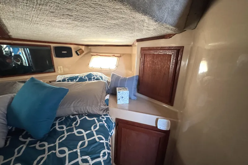 Slide: The Image of Cozy cabin interior of 1985 Bluewater Yachts 51 Coastal Cockpit MY with blue bedding. - 33