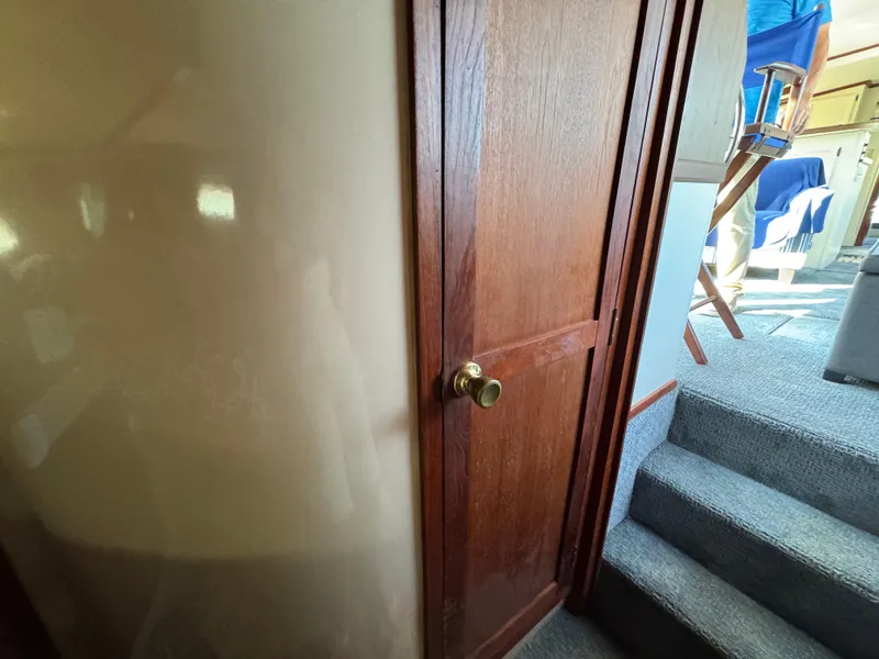 Slide: The Image of Interior of 1985 Bluewater Yachts 51 Coastal Cockpit MY, featuring wooden door and carpeted stairs. - 34