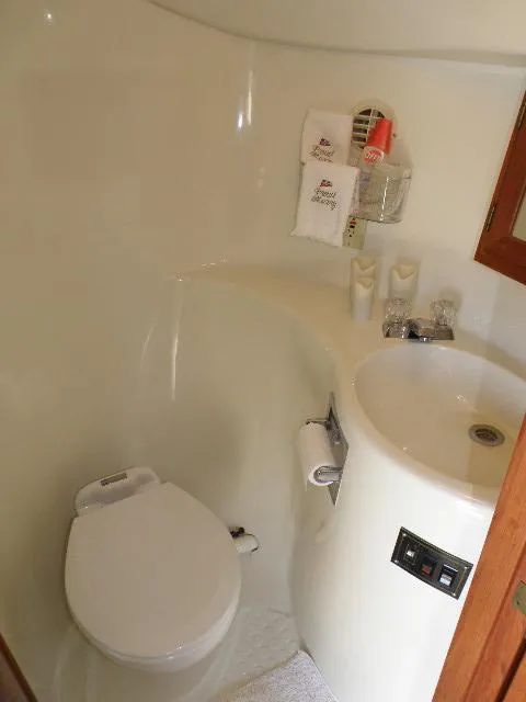 Slide: The Image of Compact bathroom in 1985 Bluewater Yachts 51 Coastal Cockpit MY, featuring toilet and sink. - 37