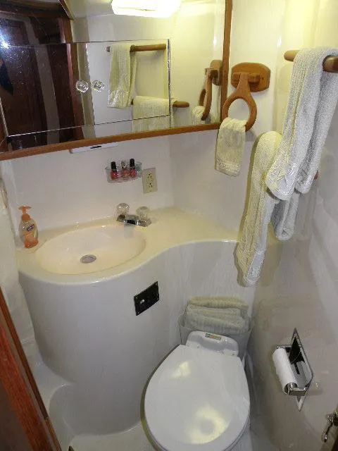 Slide: The Image of Compact bathroom in 1985 Bluewater Yachts 51 Coastal Cockpit MY, featuring sink and toilet. - 38