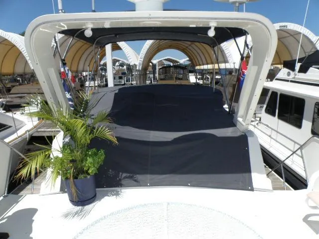 Slide: The Image of 1985 Bluewater Yachts 51 Coastal Cockpit MY, docked with canopy and potted plant. - 39