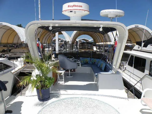Slide: The Image of 1985 Bluewater Yachts 51 Coastal Cockpit MY, featuring spacious deck and modern navigation equipment. - 40