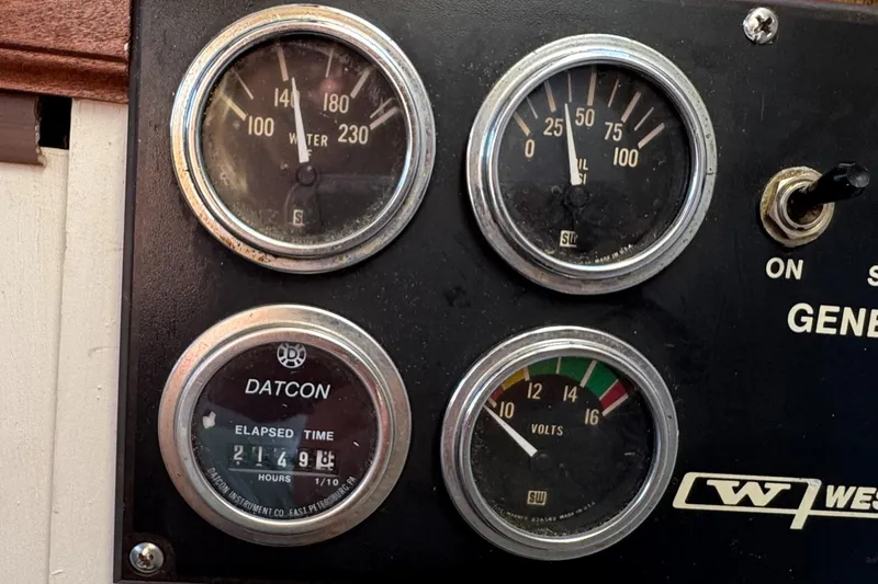Slide: The Image of Instrument panel of 1985 Bluewater Yachts 51 Coastal Cockpit MY, showing gauges and switches. - 46