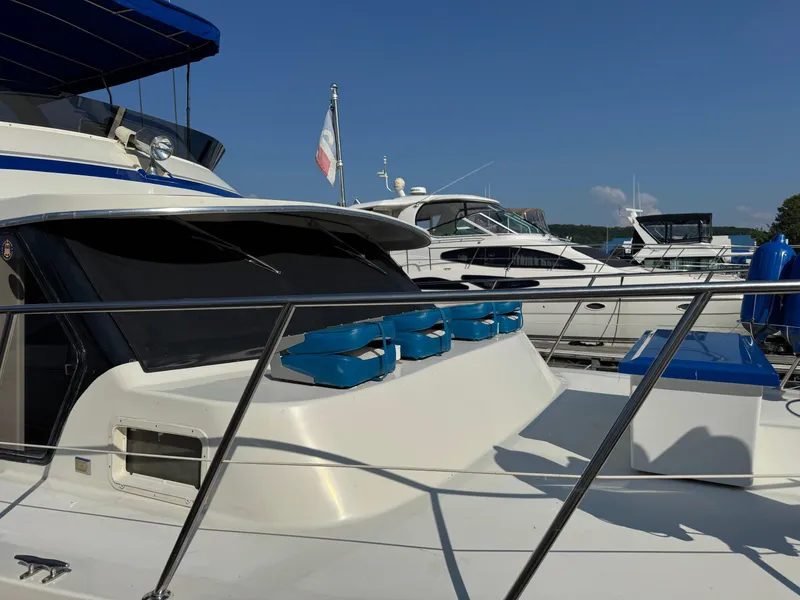 Slide: The Image of 1985 Bluewater Yachts 51 Coastal Cockpit MY docked at marina under clear blue sky. - 6