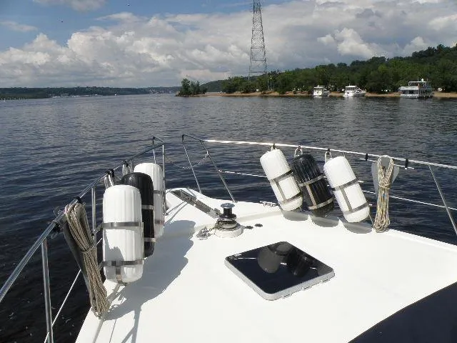 Slide: The Image of Bow view of 1985 Bluewater Yachts 51 Coastal Cockpit MY on a calm lake. - 7
