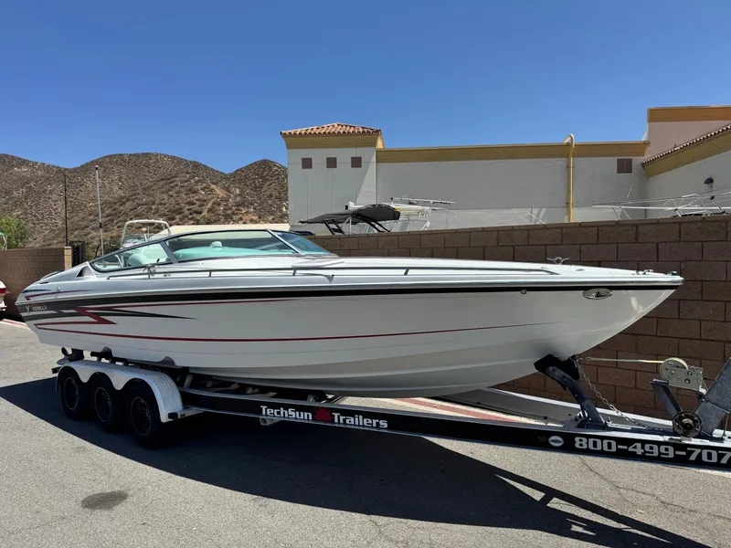 Slide: The Image of 2006 Formula 292 boat on TechSun trailer, parked outdoors under clear blue sky. - 1