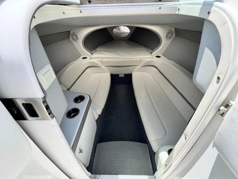 Slide: The Image of 2006 Formula 292 boat cabin interior with white seating and cup holders. - 13