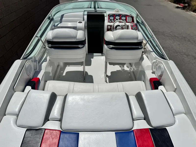 Slide: The Image of Interior of a 2006 Formula 292 boat with white seating and colorful accents. - 26