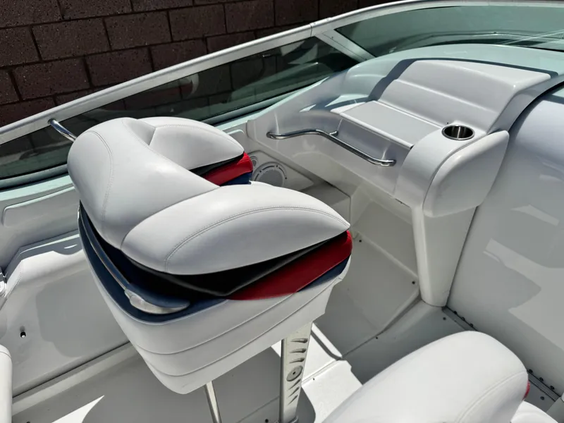 Slide: The Image of Interior of a 2006 Formula 292 boat with white seating and dashboard. - 27