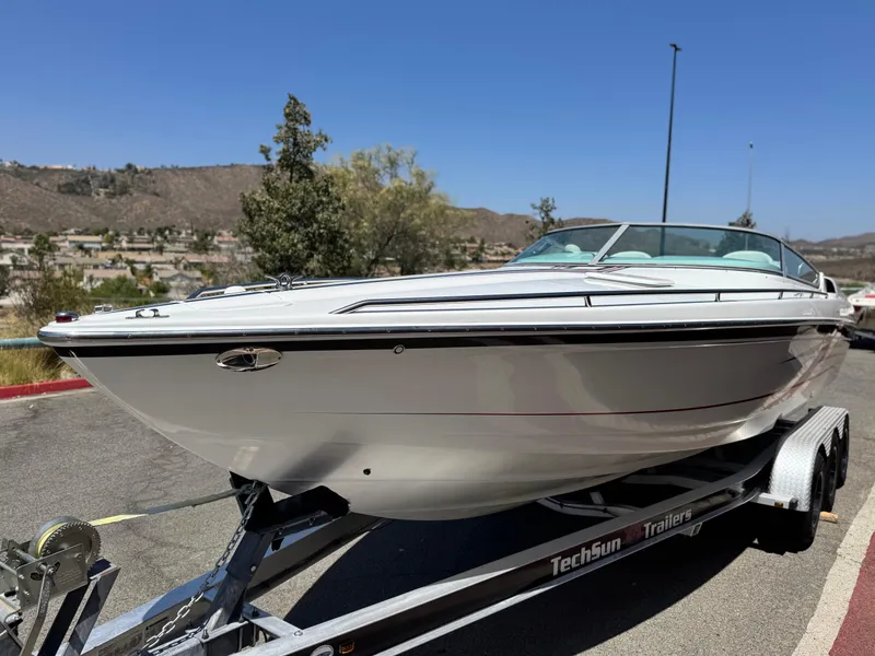Slide: The Image of 2006 Formula 292 boat on TechSun trailer, parked outdoors under clear blue sky. - 3