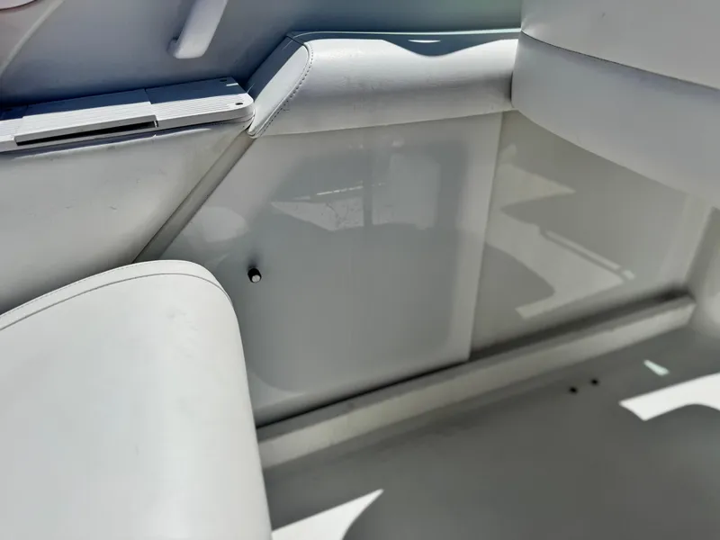 Slide: The Image of Interior of a 2006 Formula 292 boat, featuring white seating and sleek design. - 31