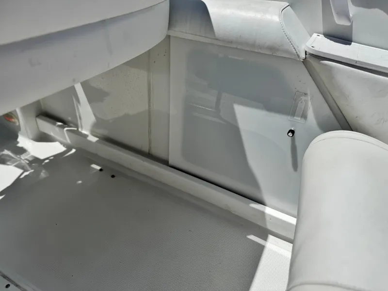 Slide: The Image of Interior of a 2006 Formula 292 boat, featuring white seating and flooring. - 33