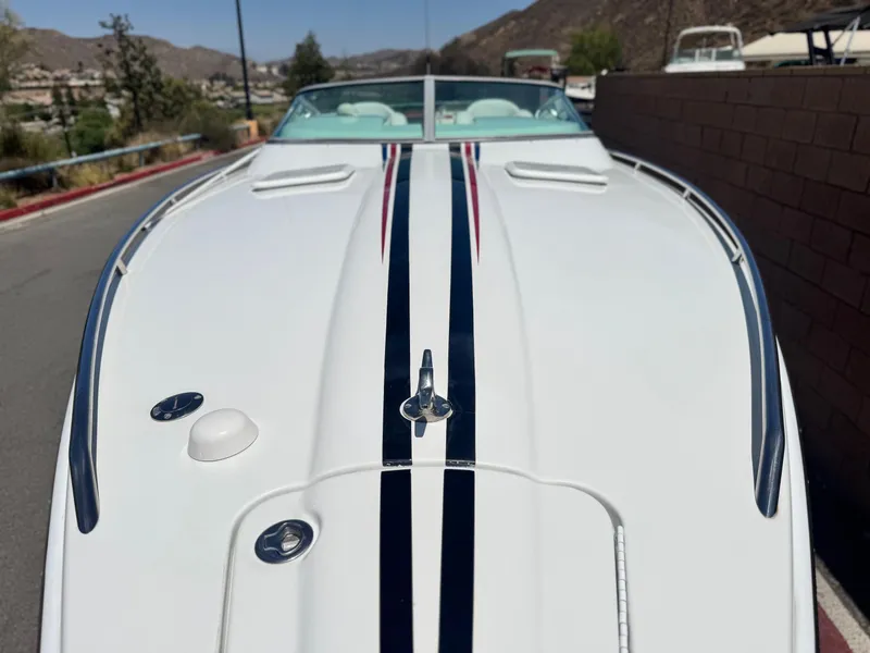 Slide: The Image of 2006 Formula 292 boat with sleek white design and blue racing stripes. - 4