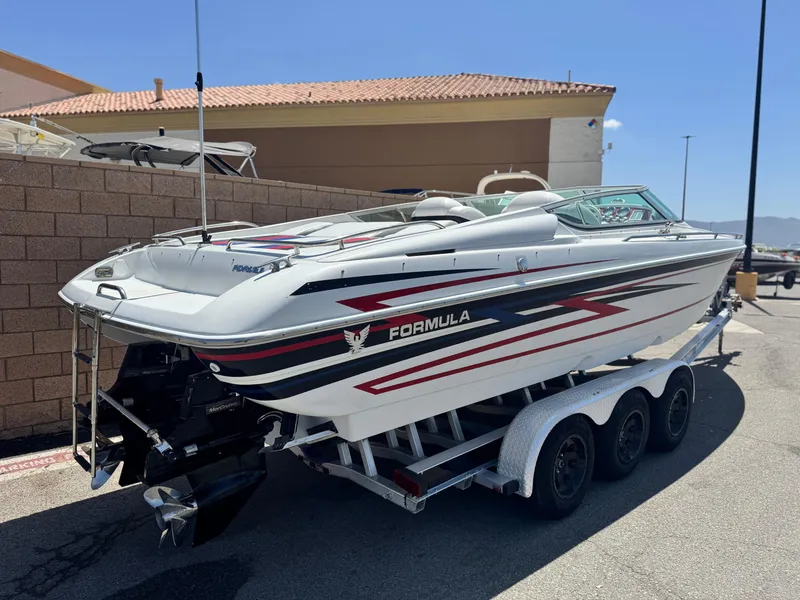 Slide: The Image of 2006 Formula 292 boat on trailer, white with red and black accents, parked outdoors. - 8