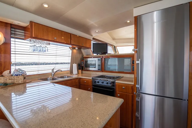 Slide: The Image of Luxurious kitchen interior of 2008 Navigator 5100 yacht with modern appliances and wood cabinetry. - 10