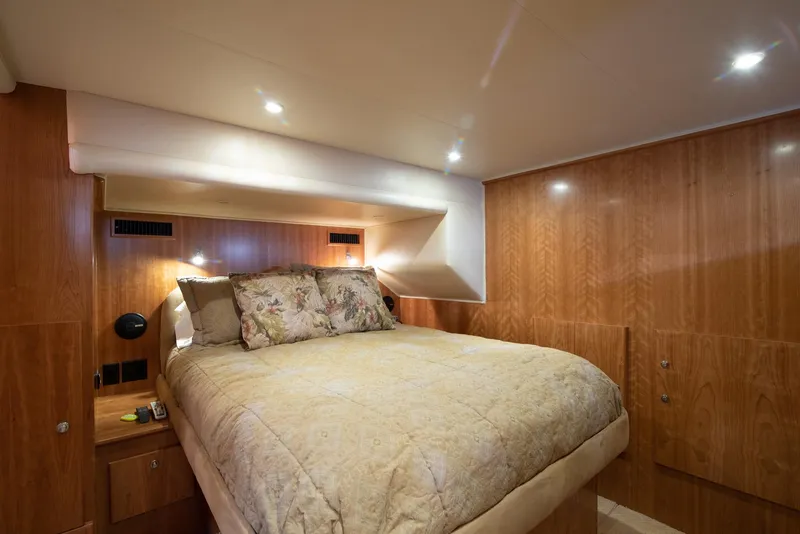 Slide: The Image of Luxurious bedroom interior on 2008 Navigator 5100 yacht with wood paneling and cozy bedding. - 11