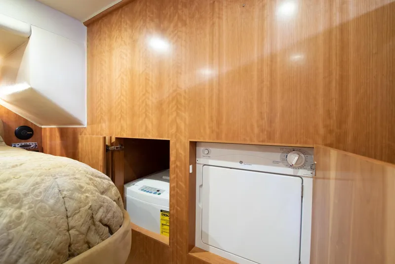 Slide: The Image of Laundry area in 2008 Navigator 5100 yacht with wood paneling and compact washer-dryer. - 12