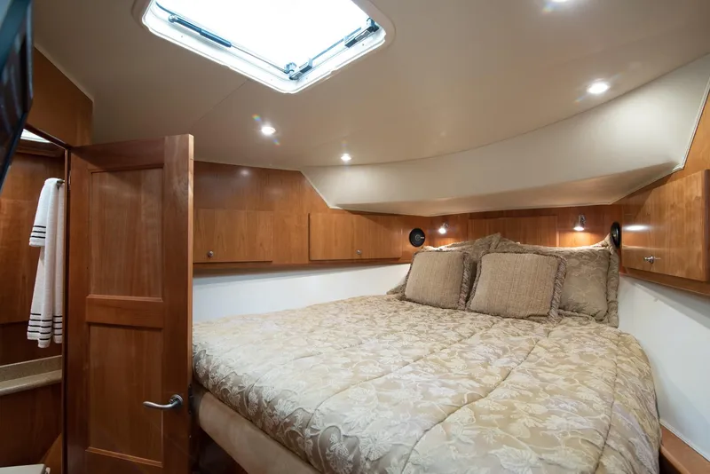 Slide: The Image of Luxurious bedroom interior of 2008 Navigator 5100 yacht with wood paneling and skylight. - 15
