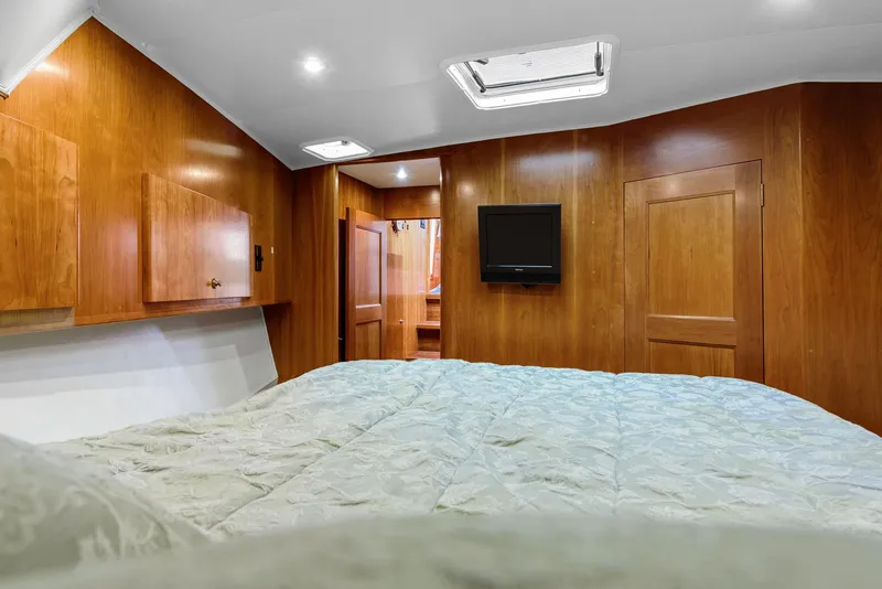Slide: The Image of Luxurious bedroom interior of 2008 Navigator 5100 yacht with wood paneling and mounted TV. - 17