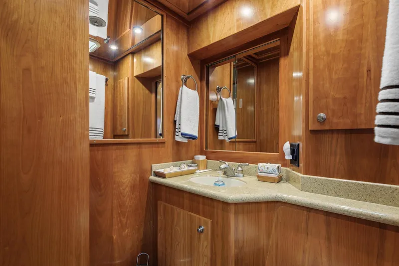 Slide: The Image of Luxurious wooden bathroom interior on 2008 Navigator 5100 yacht, featuring elegant fixtures and mirrors. - 18