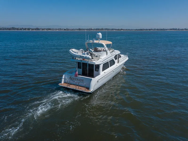 Slide: The Image of 2008 Navigator 5100 yacht cruising on open water under clear blue sky. - 2