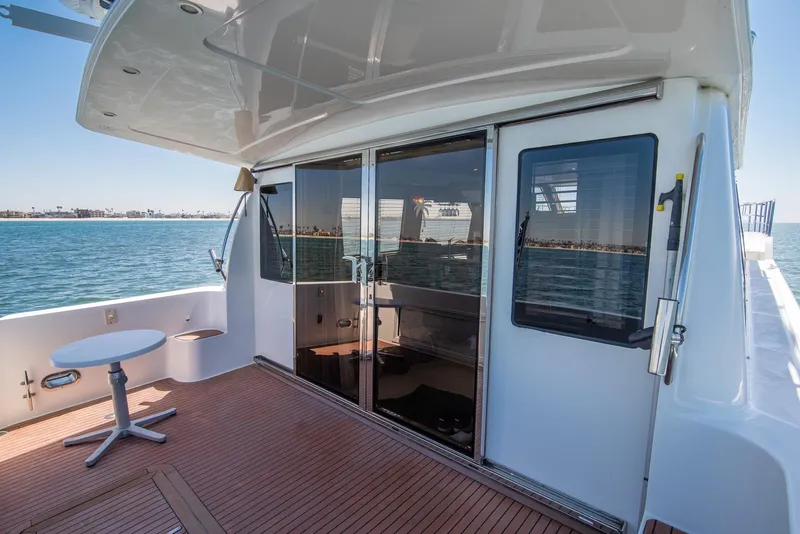 Slide: The Image of 2008 Navigator 5100 yacht deck with sliding glass doors and ocean view. - 22