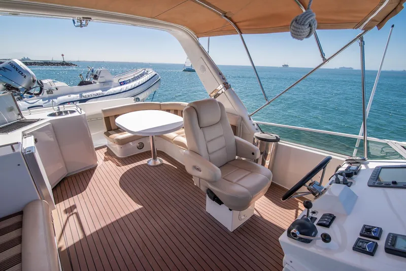 Slide: The Image of Luxurious 2008 Navigator 5100 yacht interior with helm, seating, and ocean view. - 27