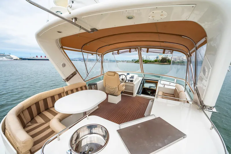 Slide: The Image of Luxurious 2008 Navigator 5100 yacht interior with seating, table, and helm, docked by the water. - 28
