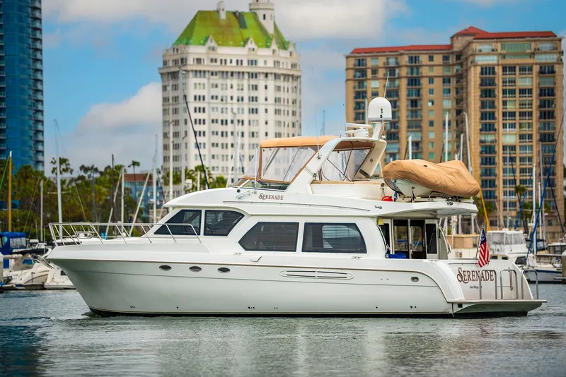 Slide: The Image of Luxury 2008 Navigator 5100 yacht docked in marina with cityscape background. - 3