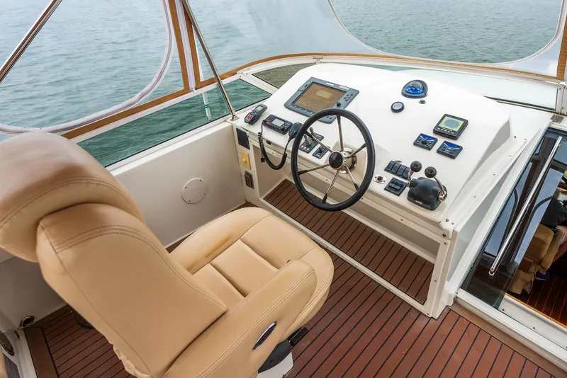 Slide: The Image of Helm of 2008 Navigator 5100 yacht with leather seat and modern controls. - 30