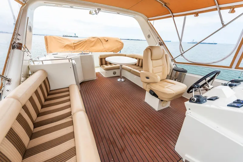 Slide: The Image of Luxurious 2008 Navigator 5100 yacht interior with striped seating, wooden flooring, and ocean view. - 32