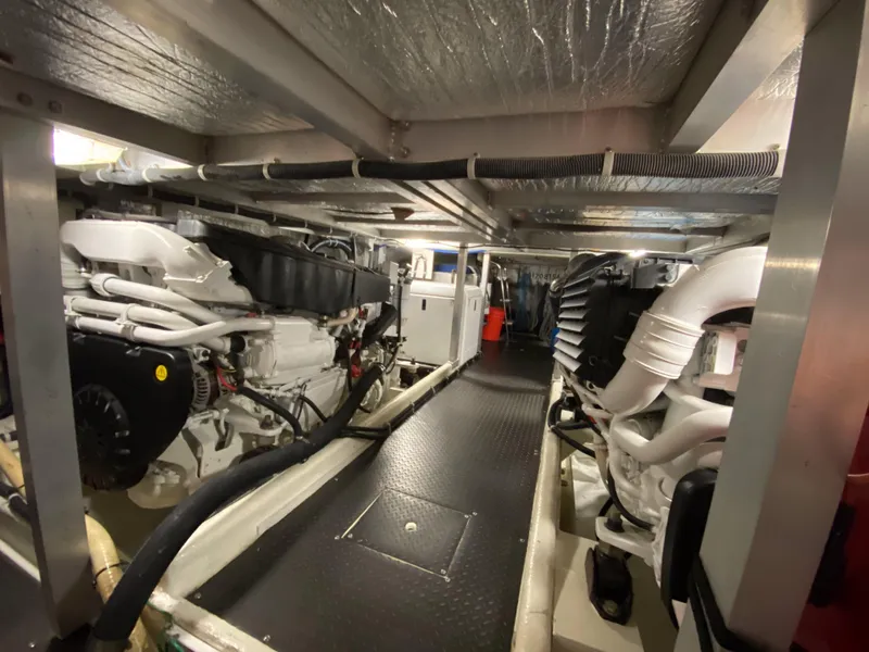 Slide: The Image of Engine room of a 2008 Navigator 5100 yacht, showcasing dual engines and mechanical systems. - 38