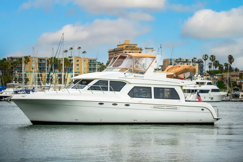 Slide: The Image of 2008 Navigator 5100 yacht docked in marina with cityscape background. - 47