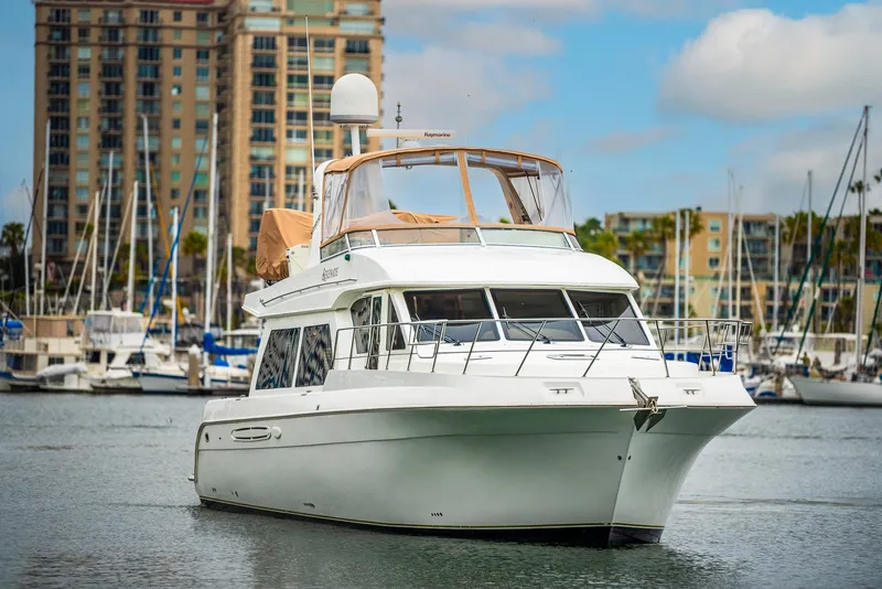 Slide: The Image of 2008 Navigator 5100 yacht in marina with cityscape background. - 49