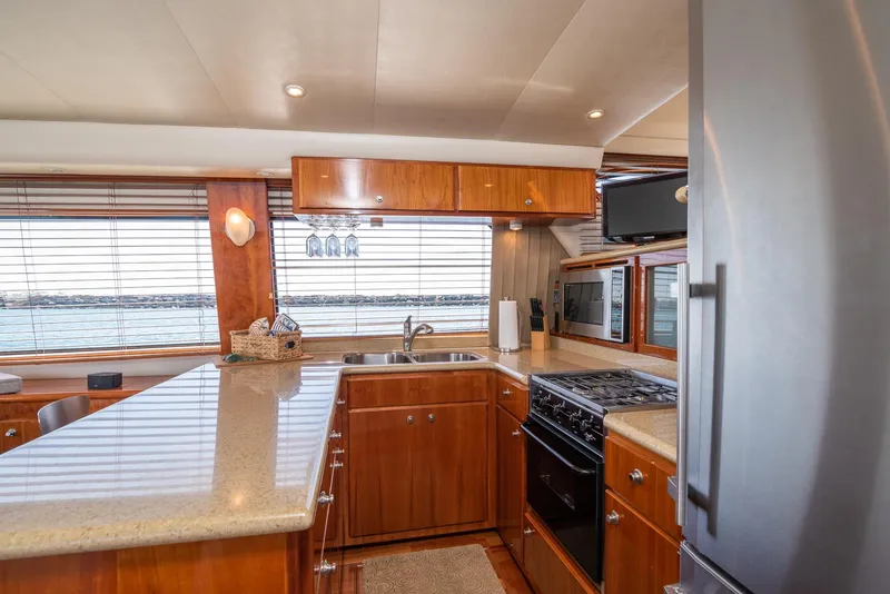 Slide: The Image of Luxurious kitchen interior of 2008 Navigator 5100 yacht with wooden cabinetry and modern appliances. - 7