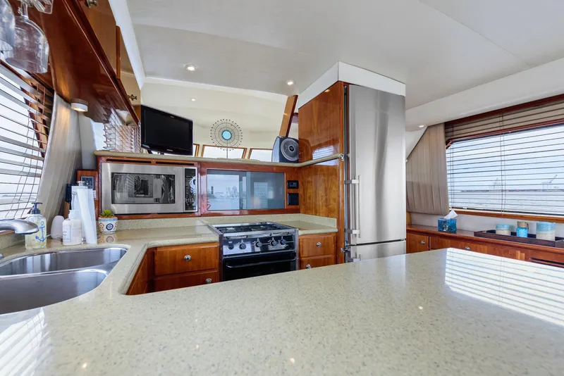 Slide: The Image of Luxurious kitchen interior on a 2008 Navigator 5100 yacht, featuring modern appliances and elegant wood finishes. - 8