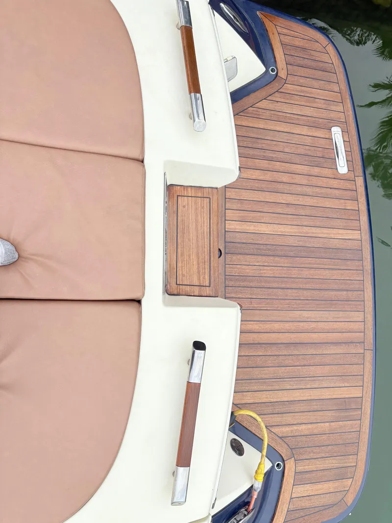 Slide: The Image of 2015 Chris-Craft Launch 32 boat with teak deck and beige seating. - 11