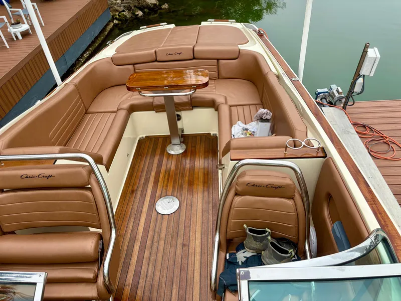Slide: The Image of 2015 Chris-Craft Launch 32 boat interior with brown leather seating and wooden deck. - 12