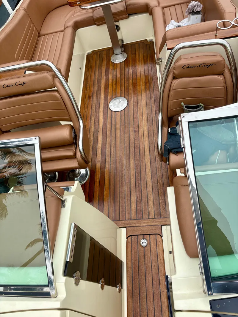 Slide: The Image of 2015 Chris-Craft Launch 32 interior with brown leather seats and wooden flooring. - 13