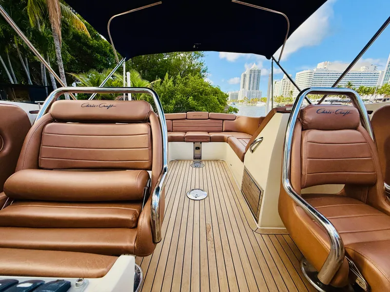 Slide: The Image of 2015 Chris-Craft Launch 32 interior with brown leather seats and wooden deck. - 18