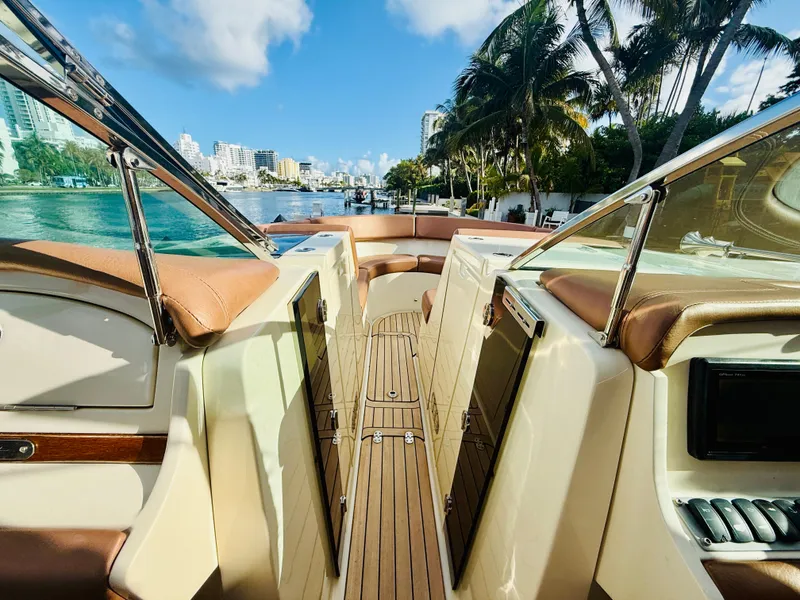 Slide: The Image of 2015 Chris-Craft Launch 32 boat interior with luxurious seating and scenic waterfront view. - 22
