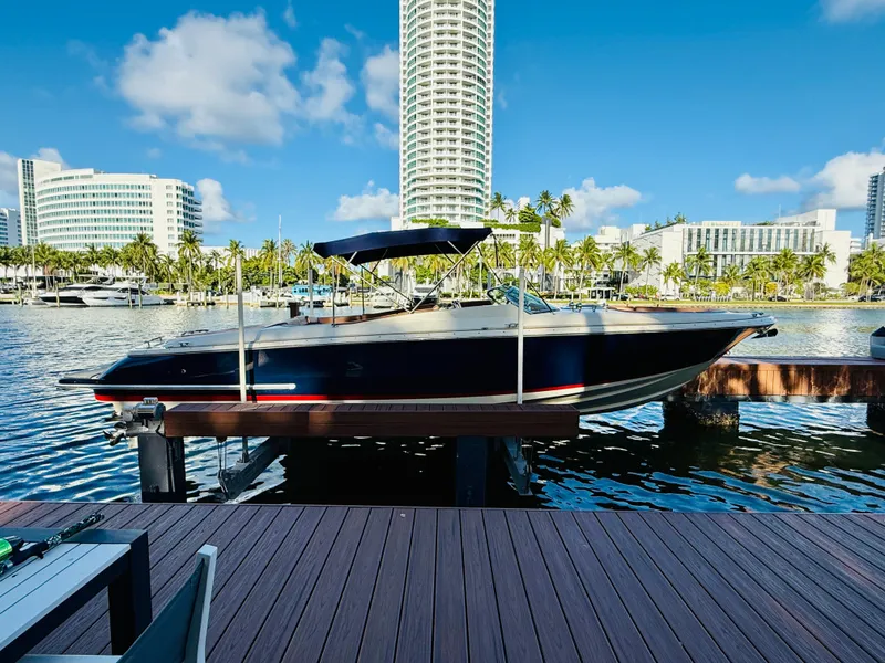 Slide: The Image of 2015 Chris-Craft Launch 32 boat docked in a marina with cityscape background. - 3