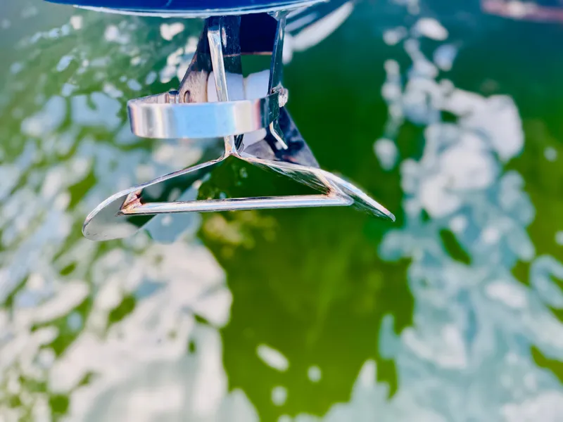 Slide: The Image of Close-up of a 2015 Chris-Craft Launch 32 boat anchor over green water. - 33