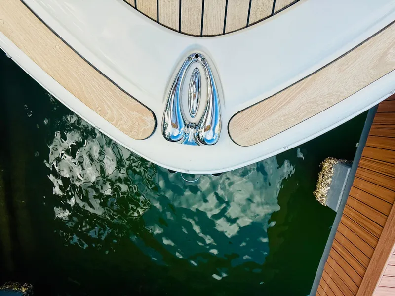 Slide: The Image of 2015 Chris-Craft Launch 32 boat bow with teak decking, docked on calm water. - 34